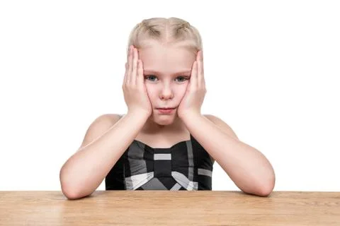 Portrait of serious child at the table Stock Photos