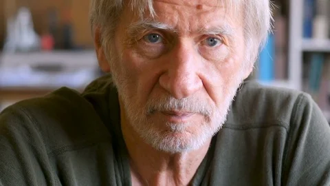 Portrait of serious elderly man looking at the camera in his home dolly shot Видео 78447475