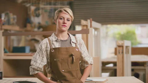 Portrait Of Serious Female Apprentice Working As Carpenter In Furniture Workshop 스톡 동영상 242361273