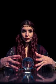 Portrait of serious fortune teller using crystal ball Fotos de archivo
