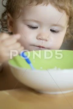 Portrait of serious male child eating Stock Photos