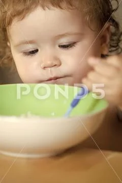 Portrait of serious male child eating Stock Photos
