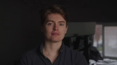 Portrait of a Serious Male Web Developer in a Dark Room Vidéo 208785482