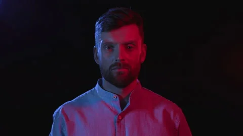 Portrait of Serious Man on Black Background. Face Expression in Colour Filter of Stock Footage 199478934