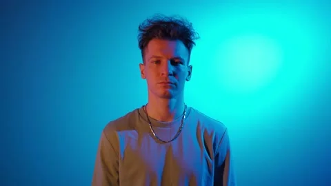 Portrait Serious Man Looking at Camera in Neon Lighting. Guy in Trendy Uv Light Stock Footage 171346471