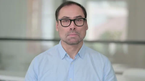 Portrait of Serious Middle Aged Man Looking at the Camera Stock Footage 162091107