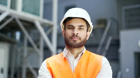 Portrait of serious professional engineer wearing safety helmet and vest standin Stock Footage 311371495