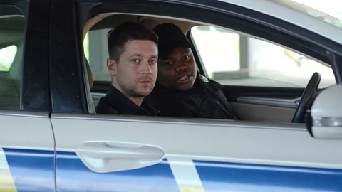 Portrait serious two men cops sitting in patrol car take photo accepting Stock Footage 112957691