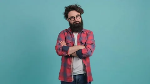 Portrait of serious young bearded guy standing with crossed hands. Stock Footage 142833293