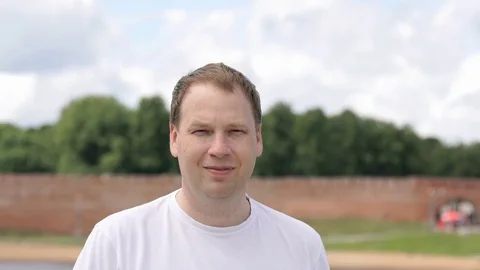Portrait of serious young man aged 40s outdoors Stock Footage 77610860
