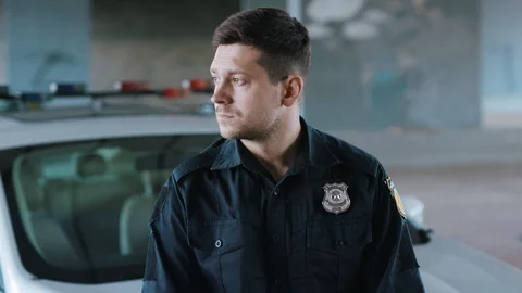 Portrait serious young man cops stand near patrol car look at camera enforcement Video stock 112997920