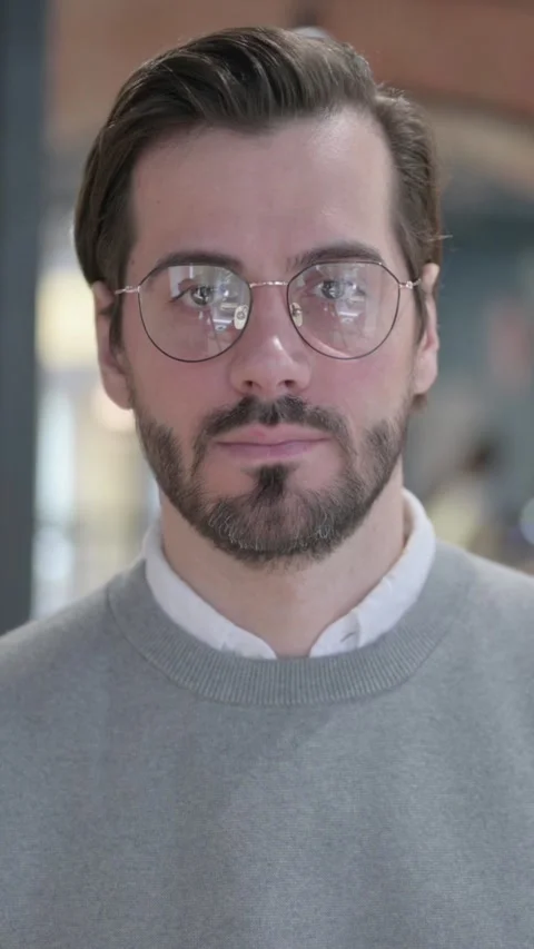 Portrait of Serious Young Man Looking at the Camera, Vertical Video 스톡 동영상 339581250