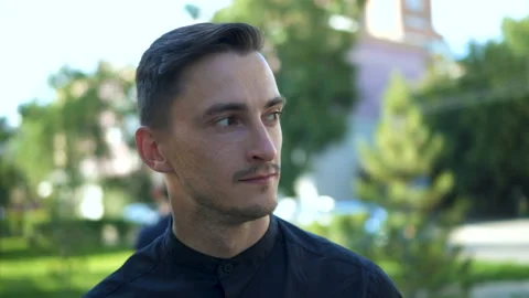 Portrait of serious young man spending free time in city park. Stock Footage 103252489