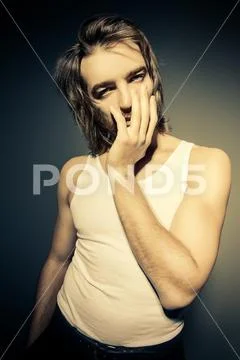 Portrait of a sexy muscular man posing at studio. Men's beauty, fashion. Stock Photos