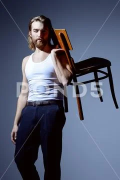 Portrait of a sexy muscular man posing at studio. Men's beauty, fashion. Stock Photos
