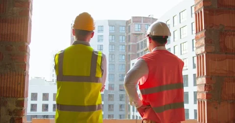 Portrait of shaking hands of two builders on built house background. Close up of Stock Footage 172286187