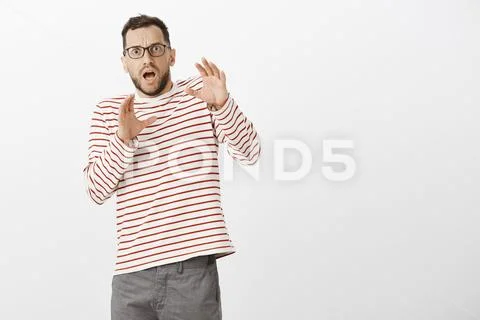Portrait of shocked terrified adult european father in glasses and striped Stock Photos
