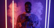 Portrait Shot Of The African American Young Man In Glasses Standing In The Neon Stock Footage