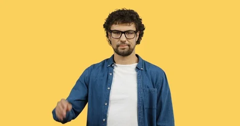 Portrait shot of the Caucasian man in glasses and jeans shirt doing gesture like Stock Footage 104231153