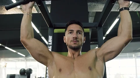 Portrait shot of confident man doing pull-ups in the gym. Video stock 99096161
