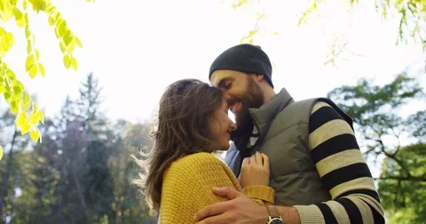 Portrait shot of cuddling and caressing romantic attractive couple standing in Stock Footage 82511202