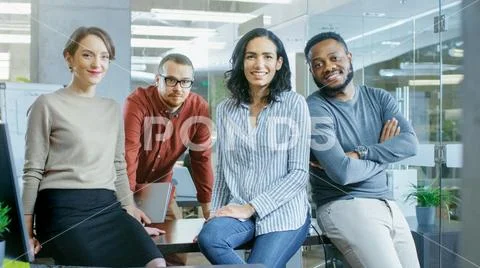 Portrait Shot of a Diverse Group of Talented Professionals Sitting on a Table Stock Photos