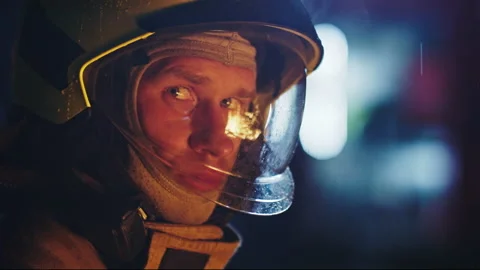 Portrait shot of a fireman in action in full uniform. Turning his head away from Stock Footage 132092744