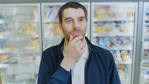 Portrait Shot of the Handsome Man Thinking Very Hard and Choosing Tin Can 動画素材 94366892