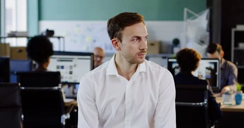 Portrait shot of handsome man in white shirt looking seriously into the camera Stock Footage 82445348