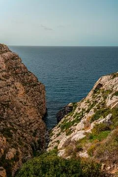 Portrait shot looking down cliffs on the Maltese south coast near blue grotto 스톡 사진