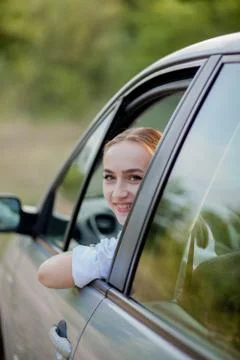 Portrait shot through windshield of pretty woman in car Foto stock