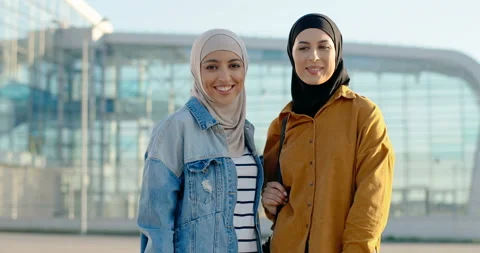 Portrait shot of two young Arabic beautiful women in traditional headscarves Stock Footage 138468193