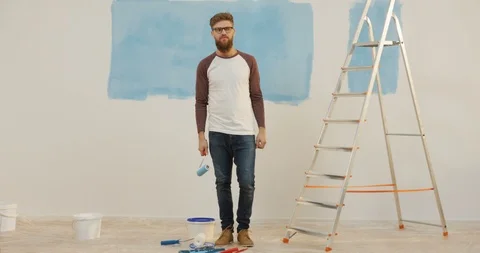 Portrait shot of the young cheerful man with a beard and in glasses posing funny Stock Footage 87587080