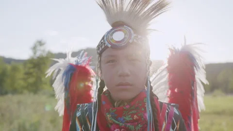 Portrait Shot of Young Indigenous Boy wearing traditional North American Regalia Stock Footage 250024274
