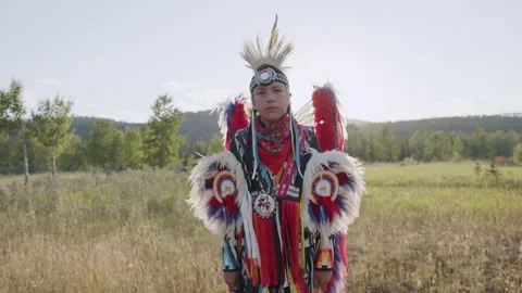 Portrait Shot of Young Indigenous Boy wearing traditional North American Regalia Stock Footage 250024521