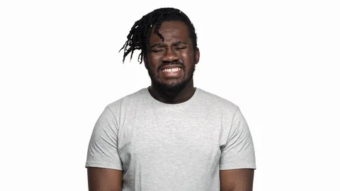 Portrait of sick afro man in basic t-shirt rubbing temples and touching forehead Stock Footage 91124725
