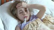 Portrait Sick Girl 7 Years Old Lying On A Bed With Thermometer. Top View Stock Footage