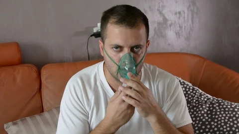 The portrait of a sick man makes inhalation, asthma hard breath. Vídeo Stock 95994374