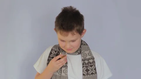 Portrait of sick sad young boy. Child drinks medicine himself. Ill throat Stock-Footage 99859901