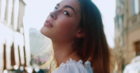 Portrait side frame attractive young woman standing on city street turning open Stock Footage 200957299