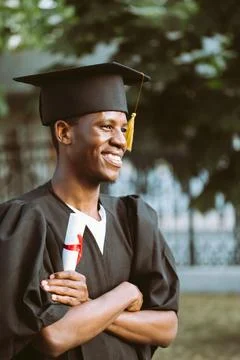 Portrait side view of happy afro american graduate from university stand Stock Photos