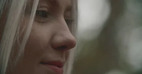 Portrait of side view of young and beautiful woman smiling looking at the 스톡 동영상 140779849