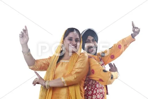 Portrait of Sikh couple doing bhangra dance Stock Photos