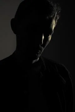 Portrait of a silhouette of a guy in the dark Stock Photos