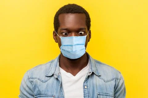 Portrait of silly crazy man with surgical medical mask crossing eyes looking  Stock Photos