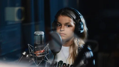 Portrait singer child is training to make music in professional studio sound Stock Footage 98216487