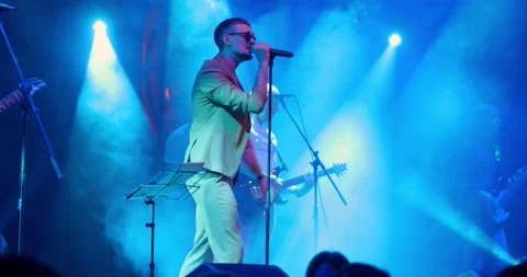 Portrait of singer man in glasses performing on stage at concert. Singer singing Stock-Footage 195542791