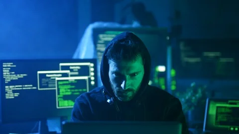 Portrait of sinister computer hacker working with codes breaking into security Stock Footage 108822669