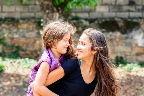 Portrait of sisters having fun together on sunny day outdoors Stock Photos