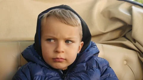 Portrait of sitting serious thinking 5 years old boy in hood Stock Footage 167331685